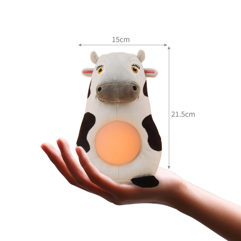 Hand holding the cow toy to demonstrate its size, with measurements for height and width provided.