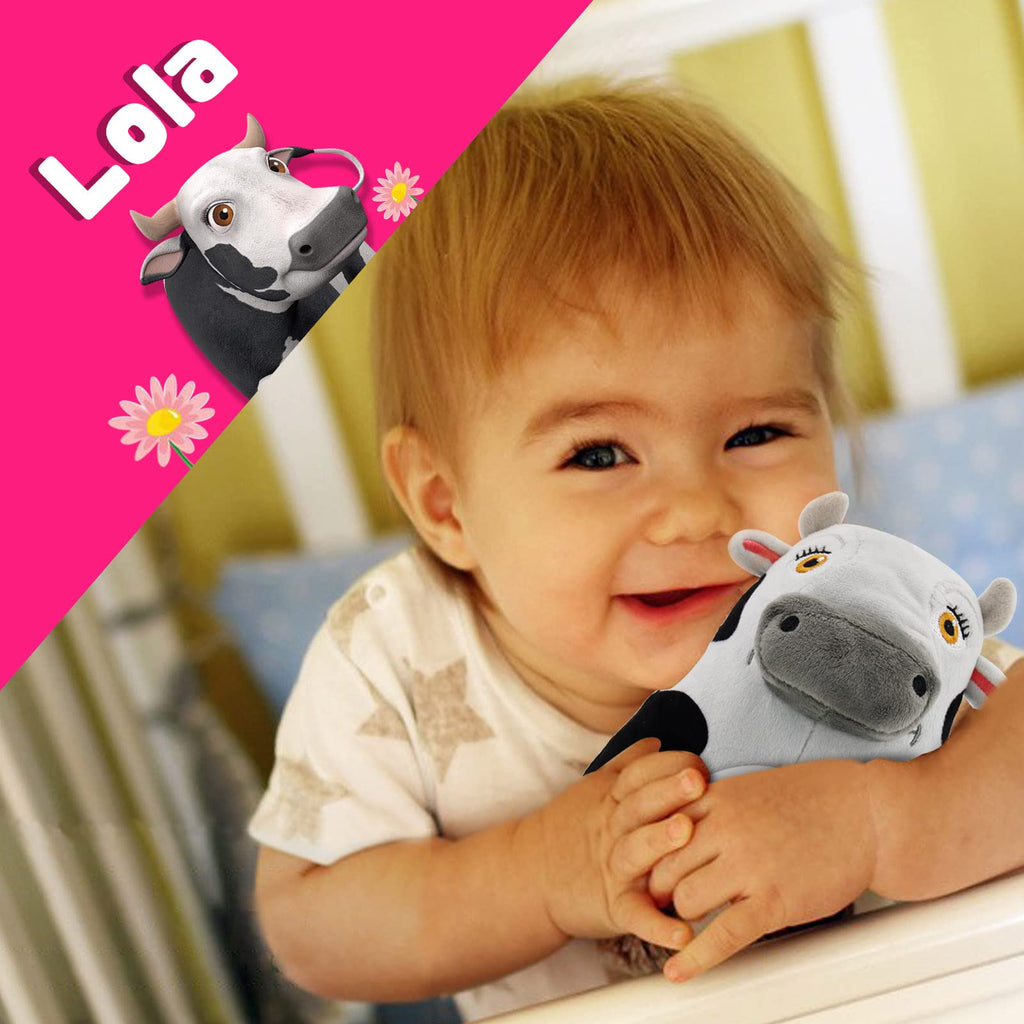 Baby laughing while holding a cow musical toy named Lola, against a vibrant pink background.