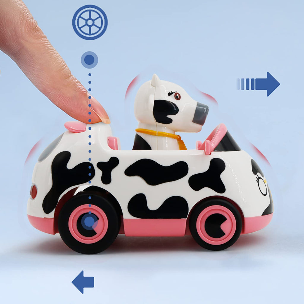 A hand demonstrating how to push the inertia-powered toy car with a cow character to make it move.